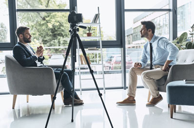 Two people talking with camera recording