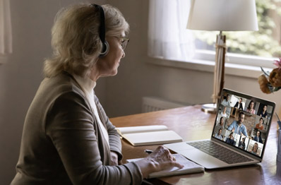 Older woman talking to others during a web meeting